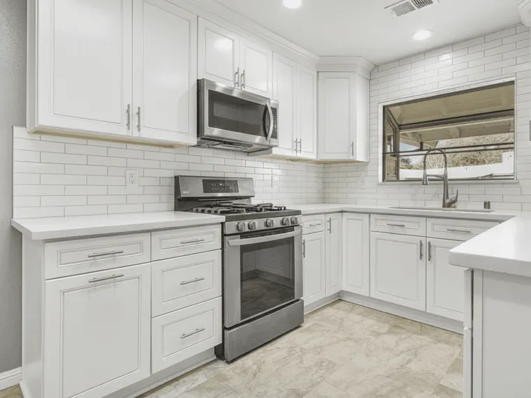 Kitchen renovation idea: dark espresso cabinets repainted classic white