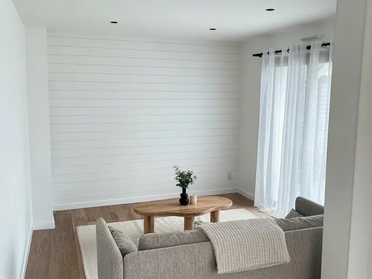 Shiplap wall paneling idea: horizontal white shiplap boards on a living room accent wall