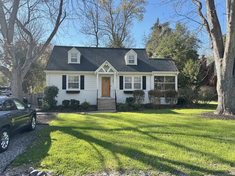 Exterior renovation idea: warm white siding with black window frames