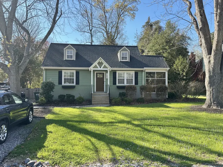 Exterior renovation idea: sage green siding with warm white trim