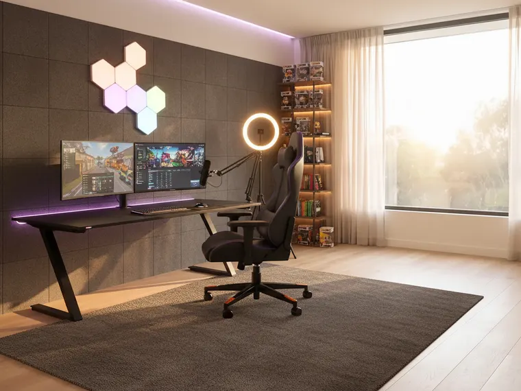 Gaming room idea for streaming: black desk with two monitors, a boom-arm microphone, a ring light, acoustic foam and a backlit shelf of figures