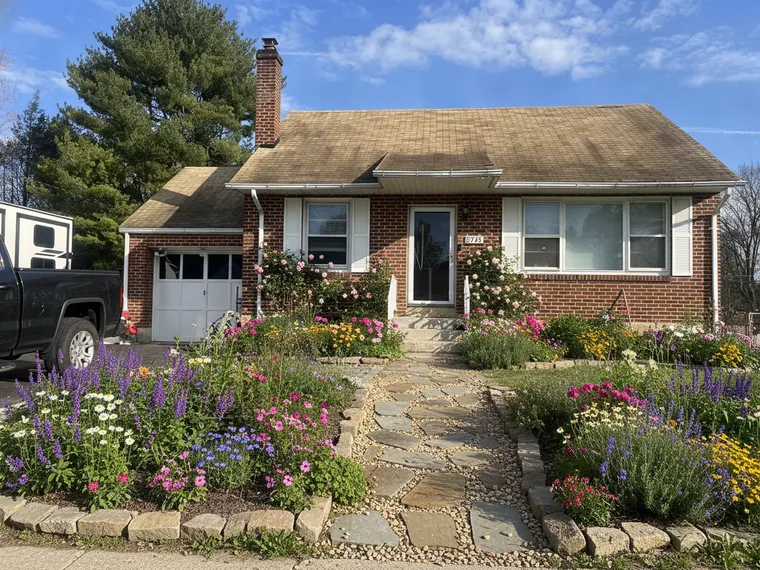 Landscaping idea: cottage garden front yard on a brick ranch