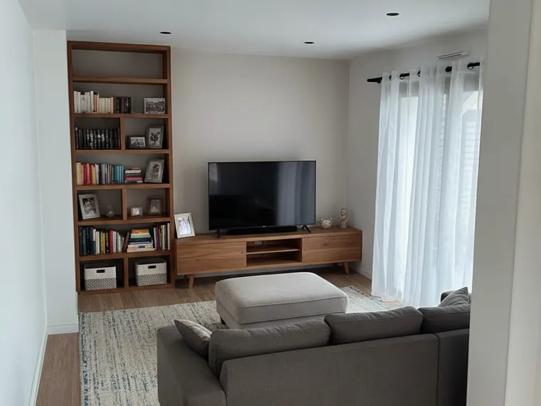 Living room idea: family room with a grey performance-fabric sectional and built-in shelving