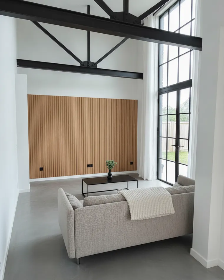 Modern barndominium living room idea: black steel truss, vertical oak slat wall, black steel-framed glass doors and polished concrete floor