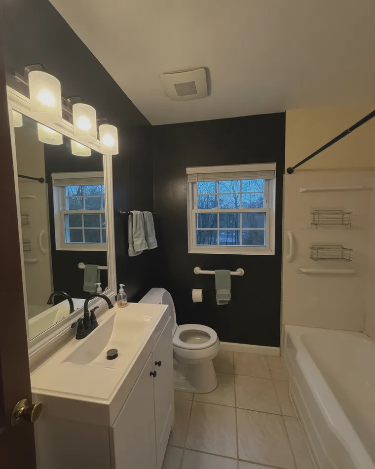 Black bathroom idea for a weekend: yellow walls repainted matte black, all fixtures and tile kept
