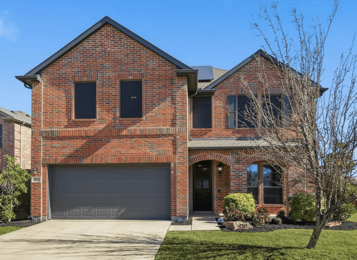 Same brick house with warm gray limewash finish and dark charcoal trim — limewash direction