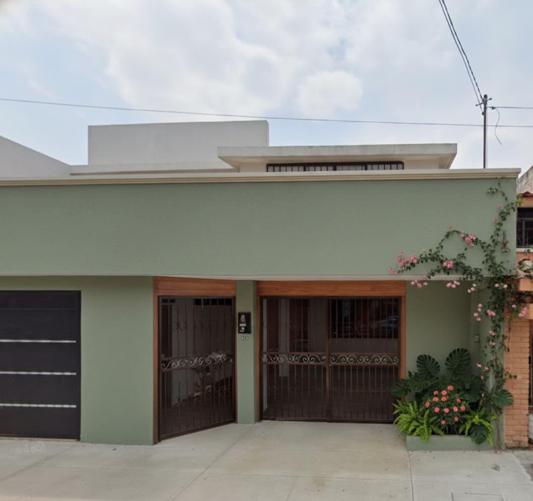 Sage green direction with wood-frame gates and flowering vine