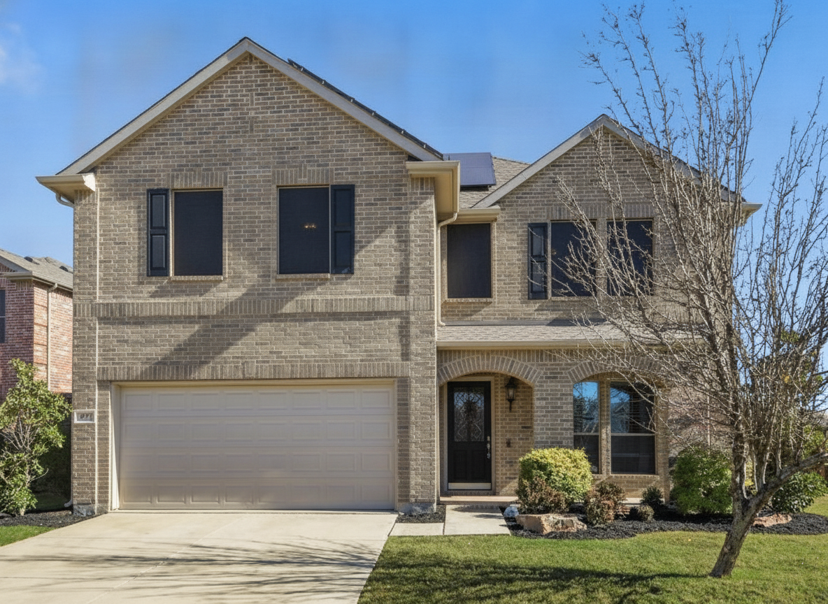 The same brick house in warm greige with black shutters and a black front door